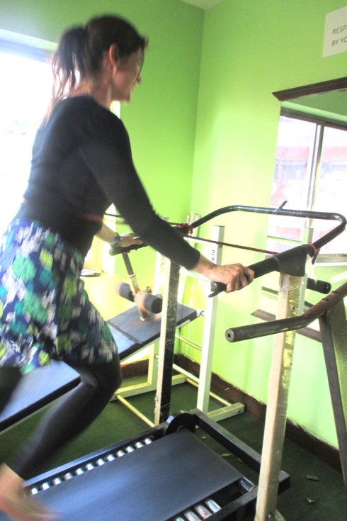 I am running on a treadmill. Barefoot. On rolling pins covered by rubber. With no power. And a red 'safety' strap.