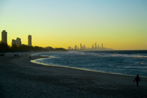 The sun whets itself behind the distant landscape.